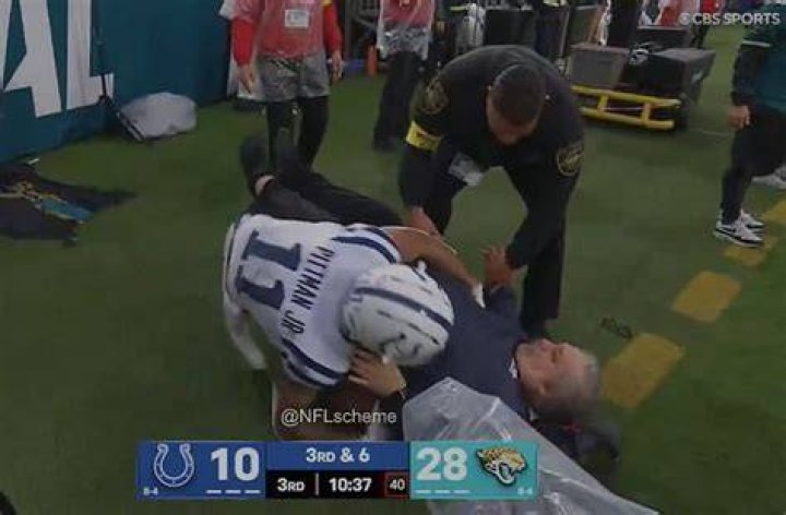 NFL sideline worker appears to break his LEG on live TV after horror collision with Saints running b
